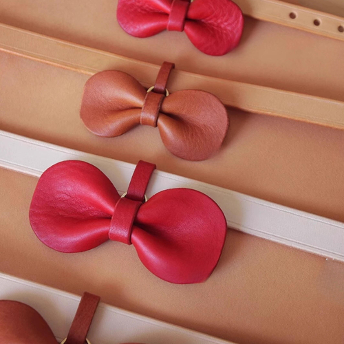 Red and pink Leather Removable Pet Bowties displayed together.